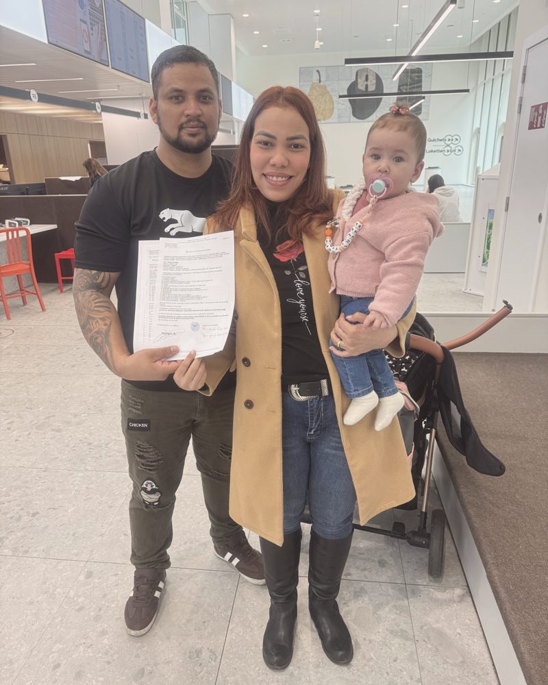 Clientes da assessoria segurando a documentação aprovada